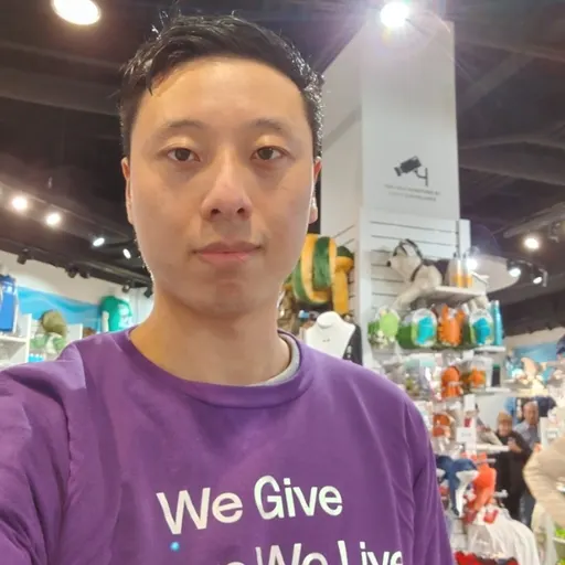 Male with dark hair and purple shirt. 