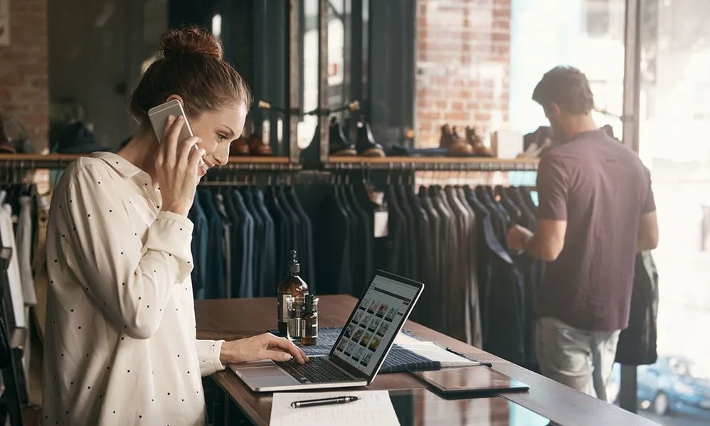 woman-working-clothing-boutique-laptop