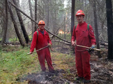 Two BC wildfire fighters in the forest