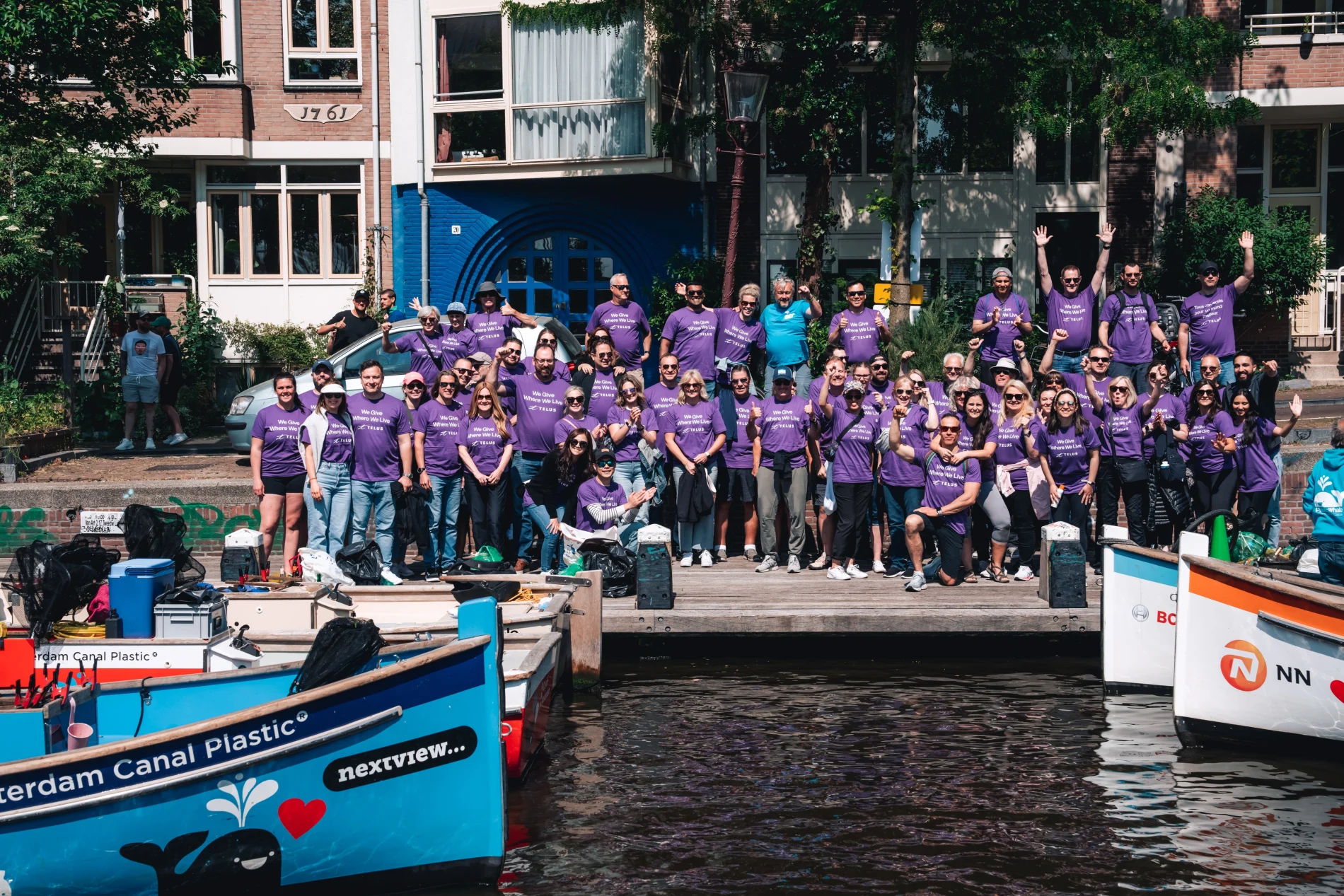 TELUS team members grouped together alongside a canal in Amsterdam.
