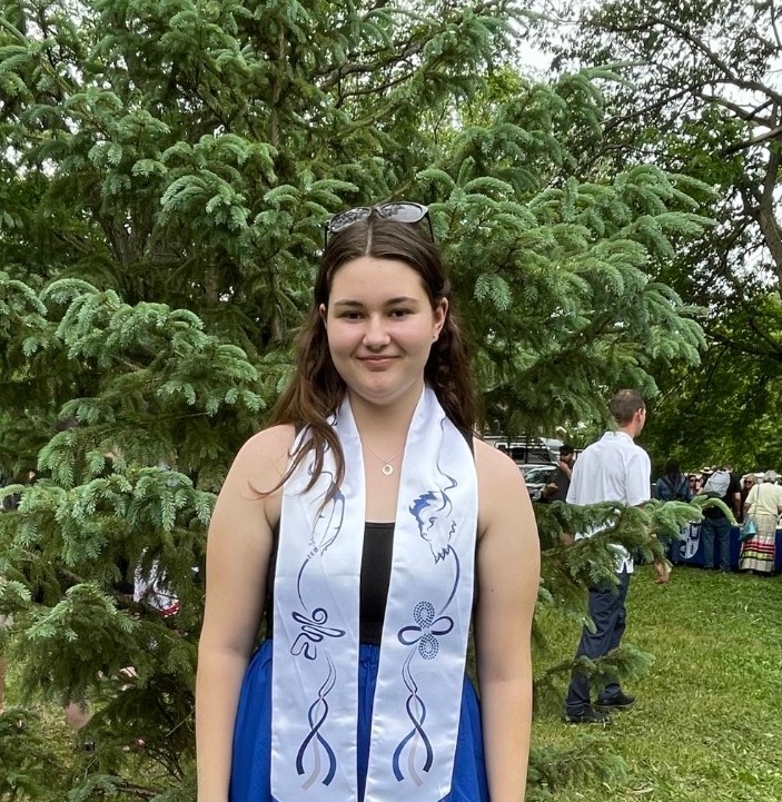 A photo of Camryn outside looking at the camera.
