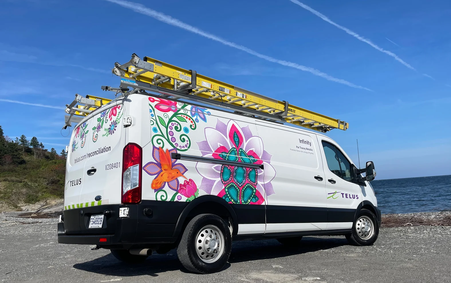 Back view of a TELUS fleet vehicle, displaying Tracey Metallic’s painting - Infinity.