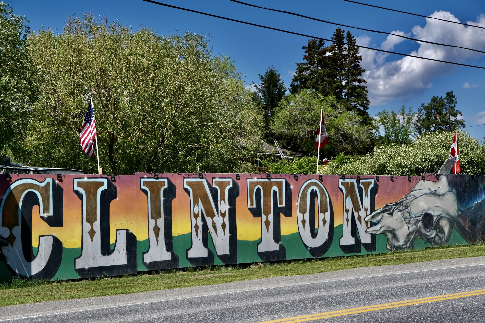 A colourful mural with the word “Clinton” painted on it decorates a fence.