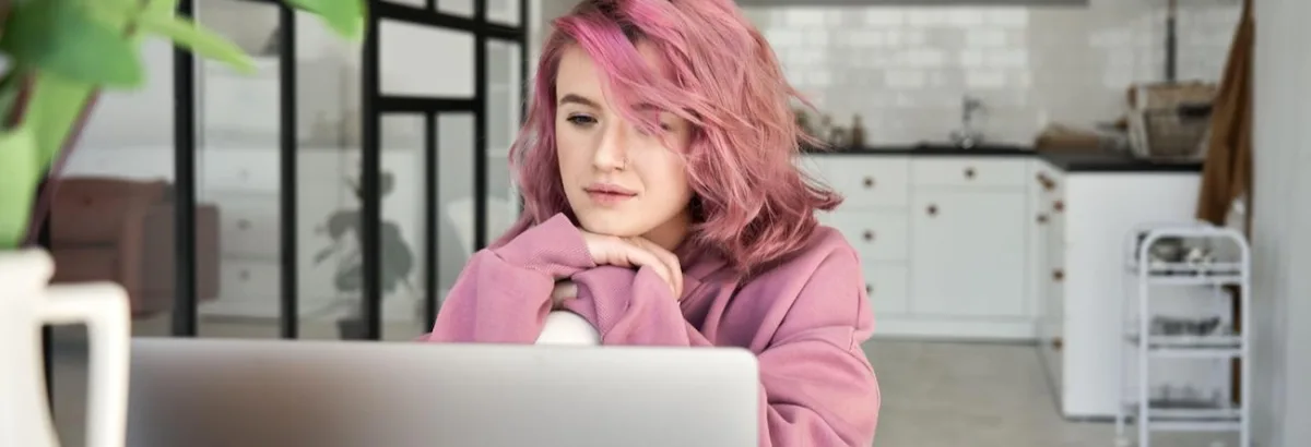 Woman video conferencing on laptop on table