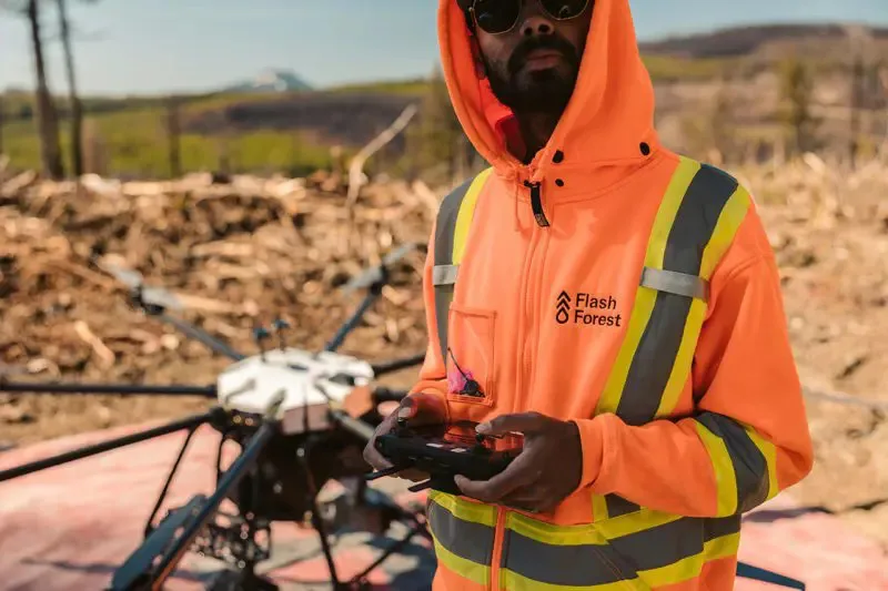 Flash Forest worker controlling drone technology.