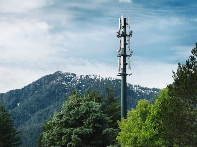 A network tower in Gold River amid mountains and trees.