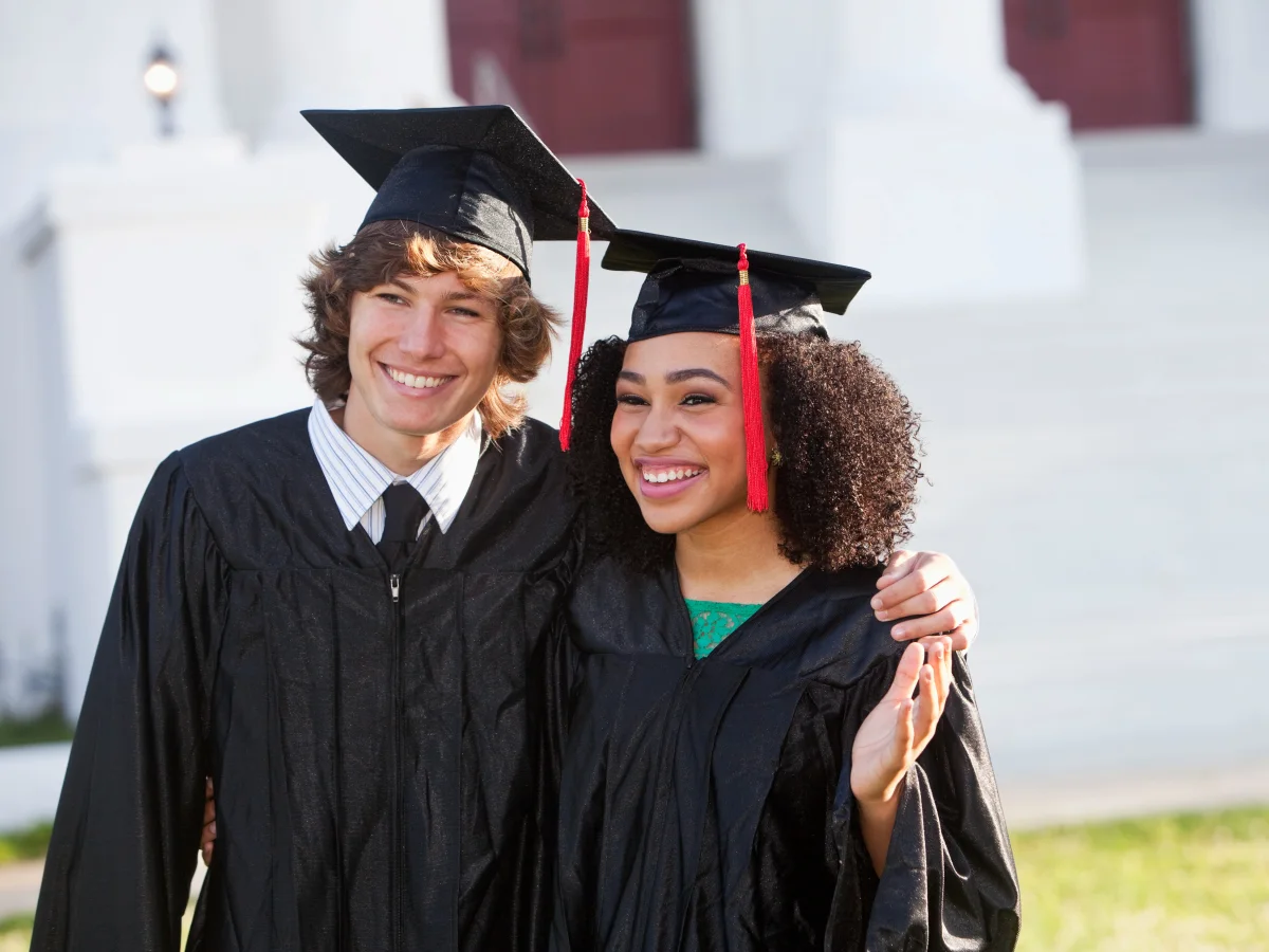 Two students in their cloak and gown at a graduation ceremony

