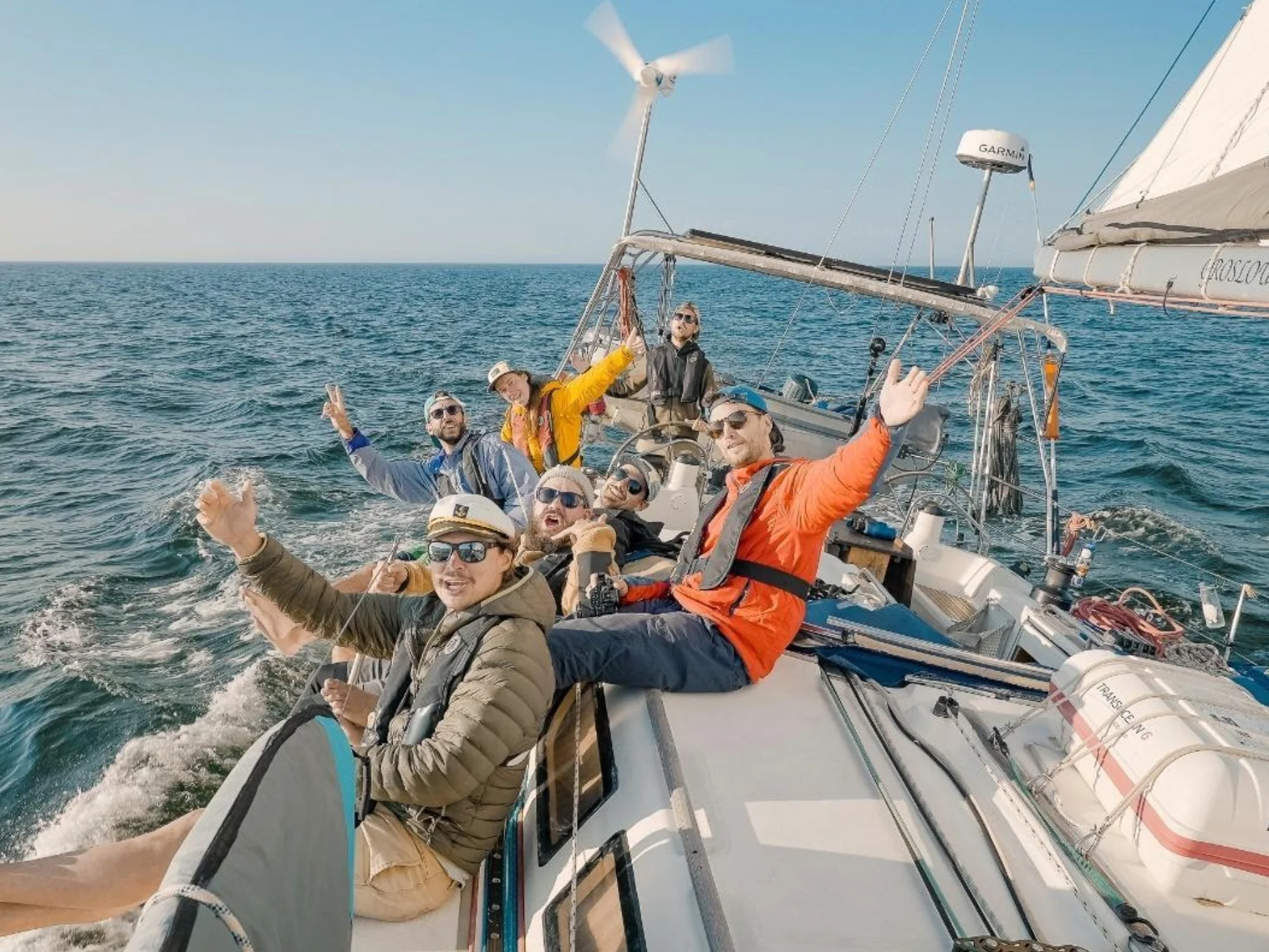 The members of the band Qualité Motel on a boat