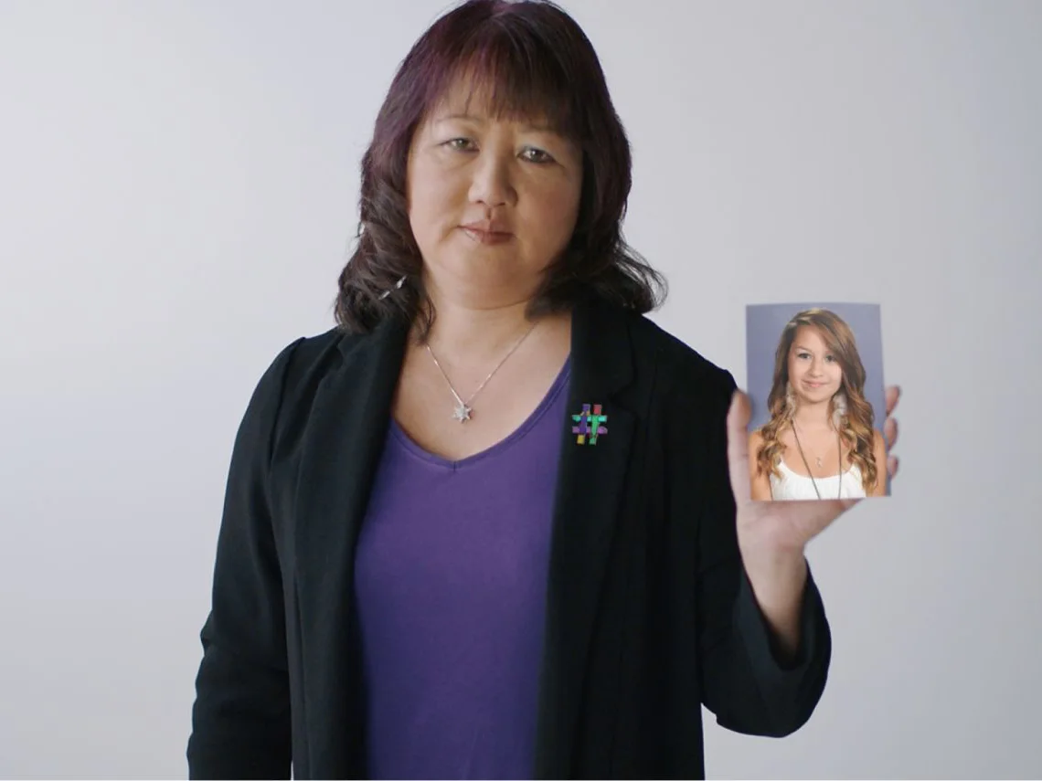 Carol Todd holding up a photo of her deceased daughter, Amanda