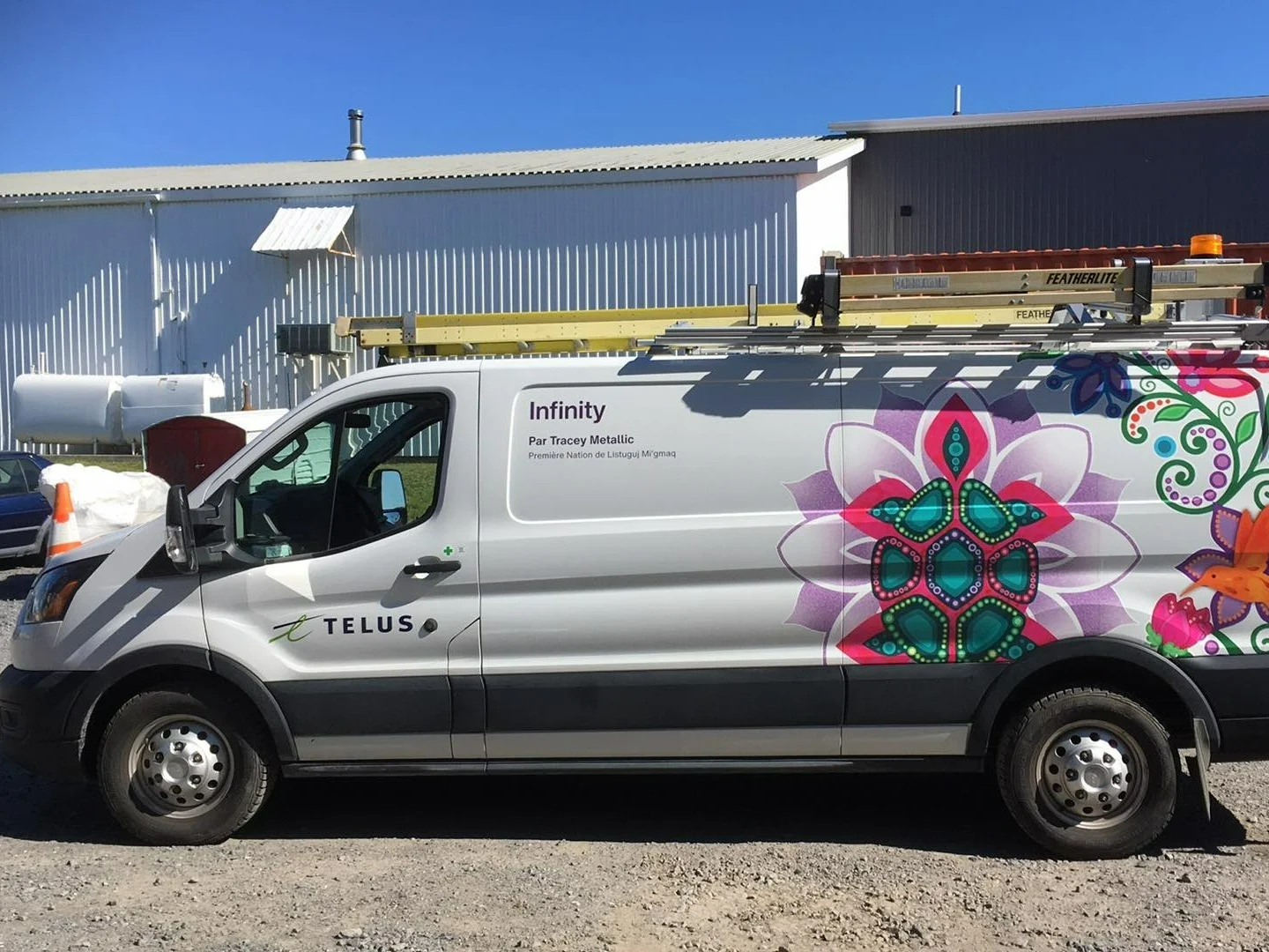 A TELUS fleet vehicle featuring artwork by local, Indigenous artist, Tracey Metallic.