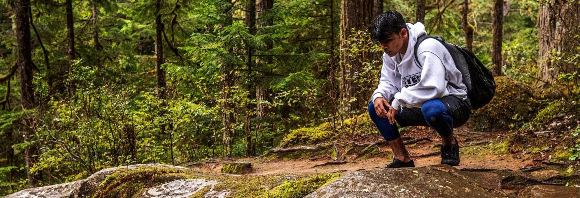 Young man hiking in the woods