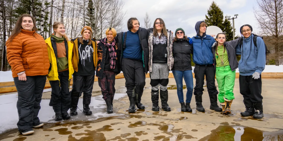 Students from the Boundless School posing for a group photo outside. 