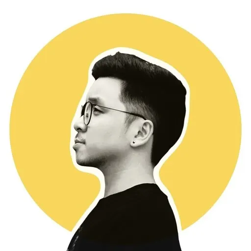 An Asian man wearing glasses in side profile