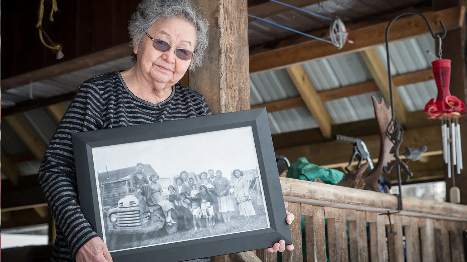 Violet Gellenbeck holds a framed photograph taken in the 1950s of four generations of her family, all fluent Witsuwit’en speakers.
