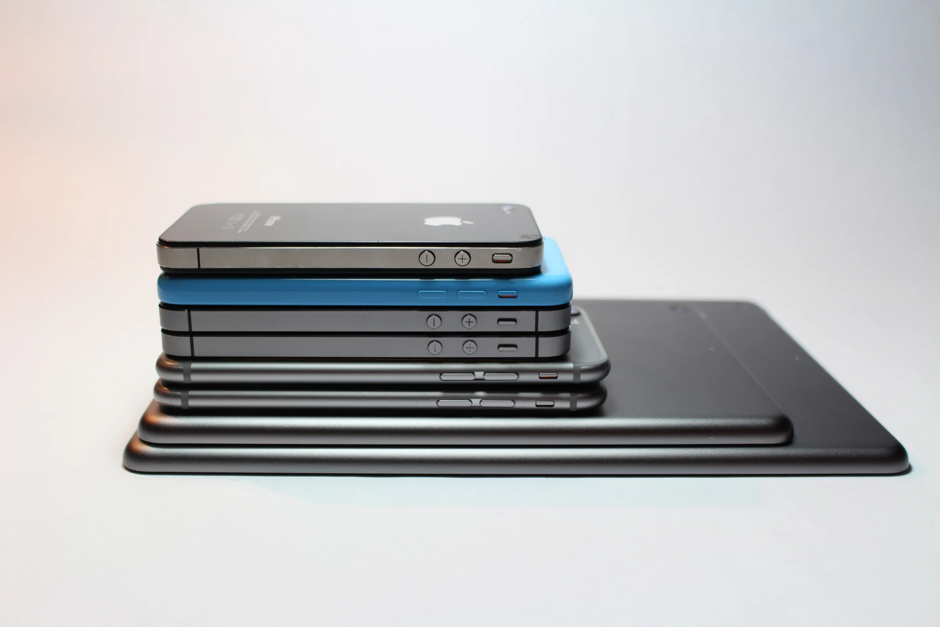 A stack of smartphones and tablets