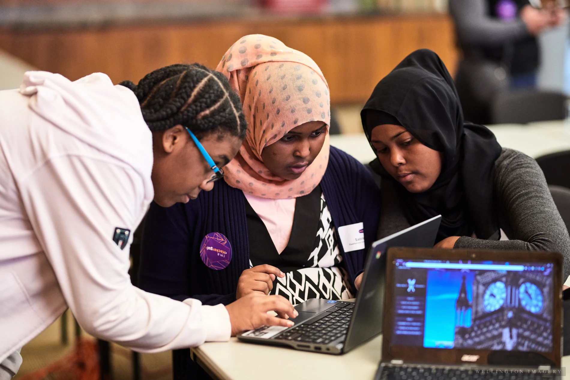 3 teenage girls working together on a laptop