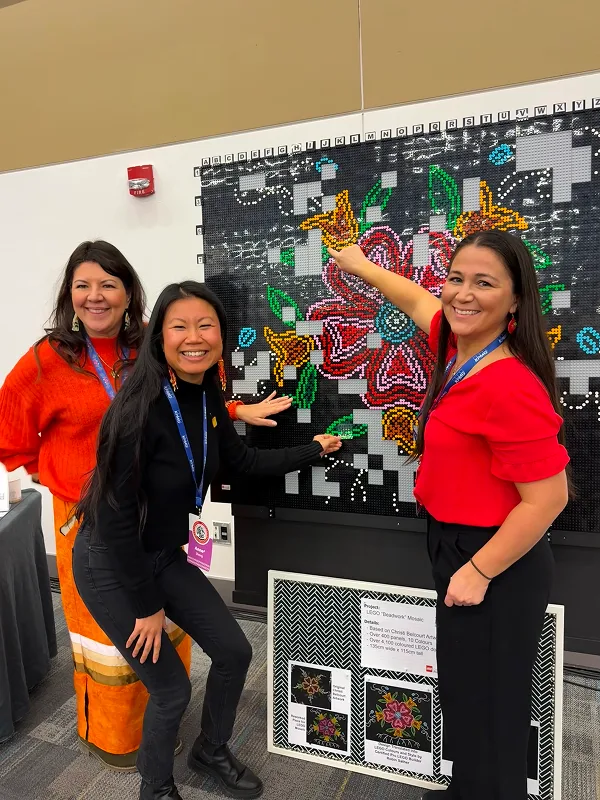 Conference attendees build a floral lego art design together