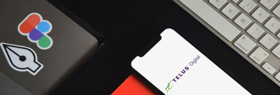 A mobile phone displaying the TELUS Digital logo next to a keyboard and laptop with stickers for NearForm and Figma
