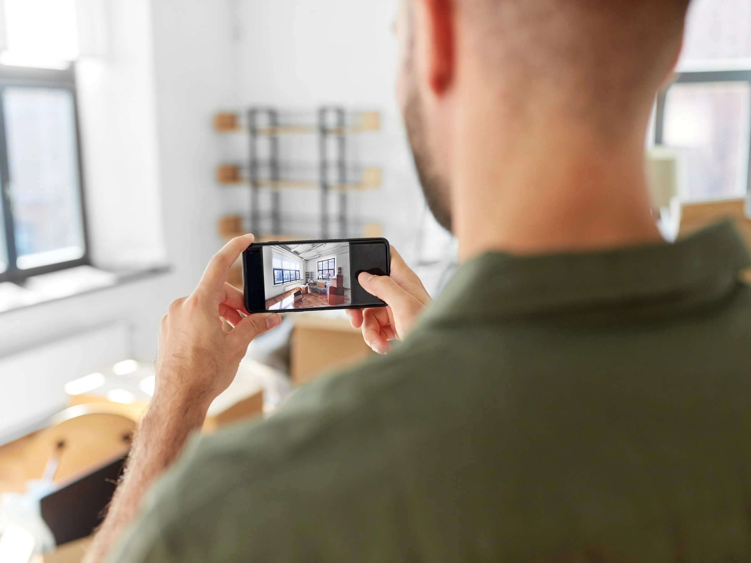 Image of a man recording with his phone