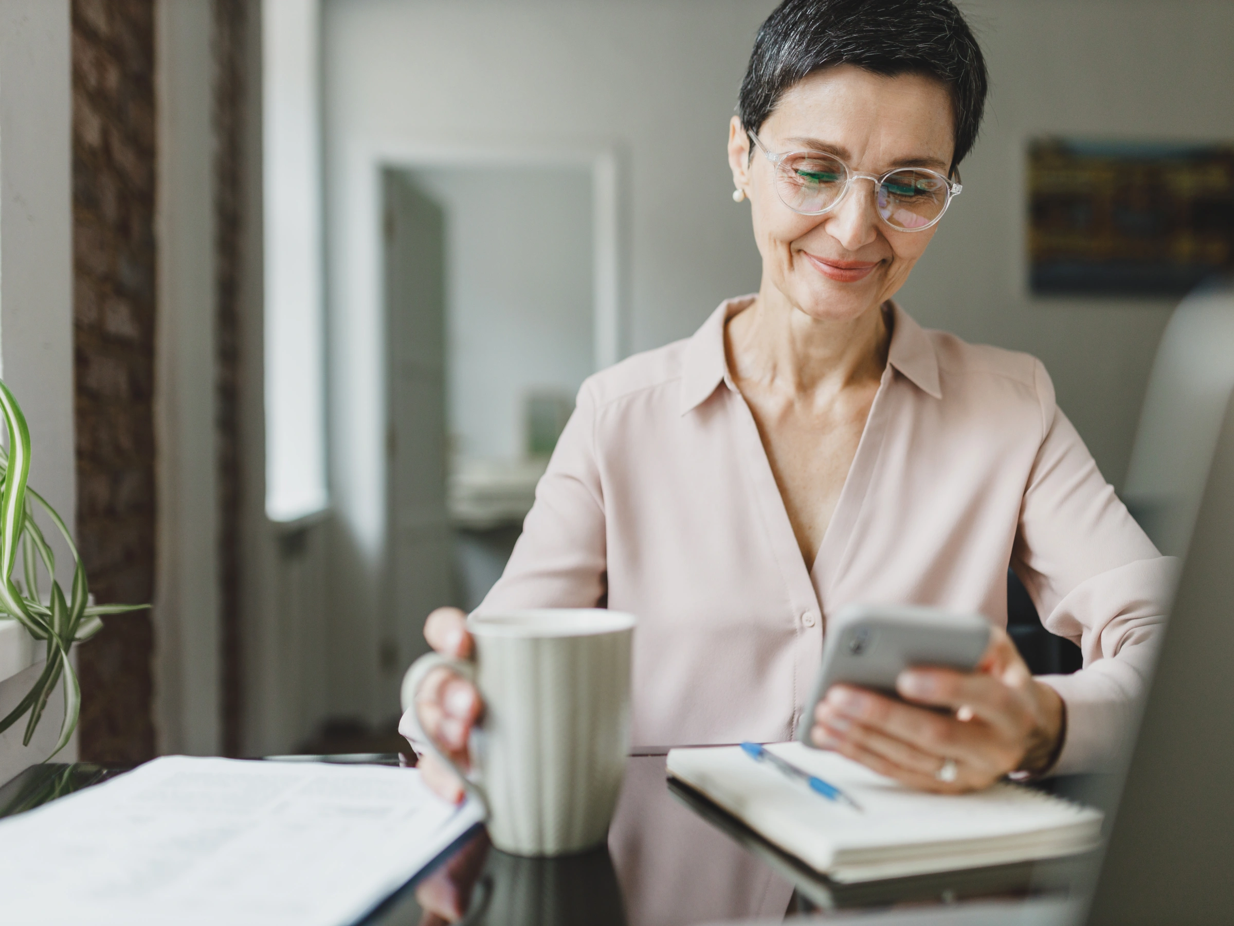 Image of an older woman looking at her phone