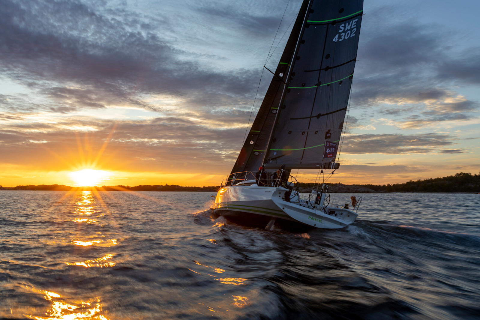 Fleet of offshore yachts approaching the start line.