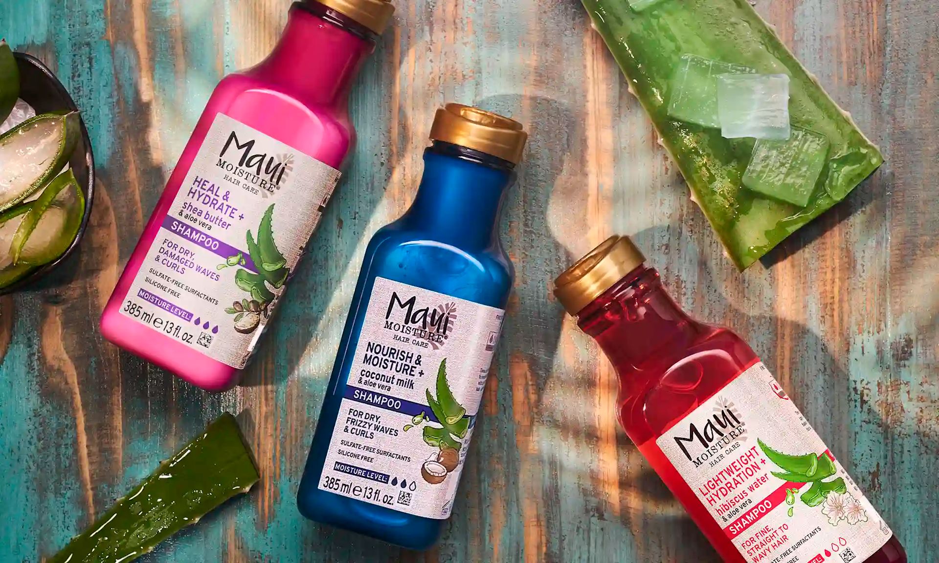 Maui Moisture® Shampoo products surrounded by aloe leaves