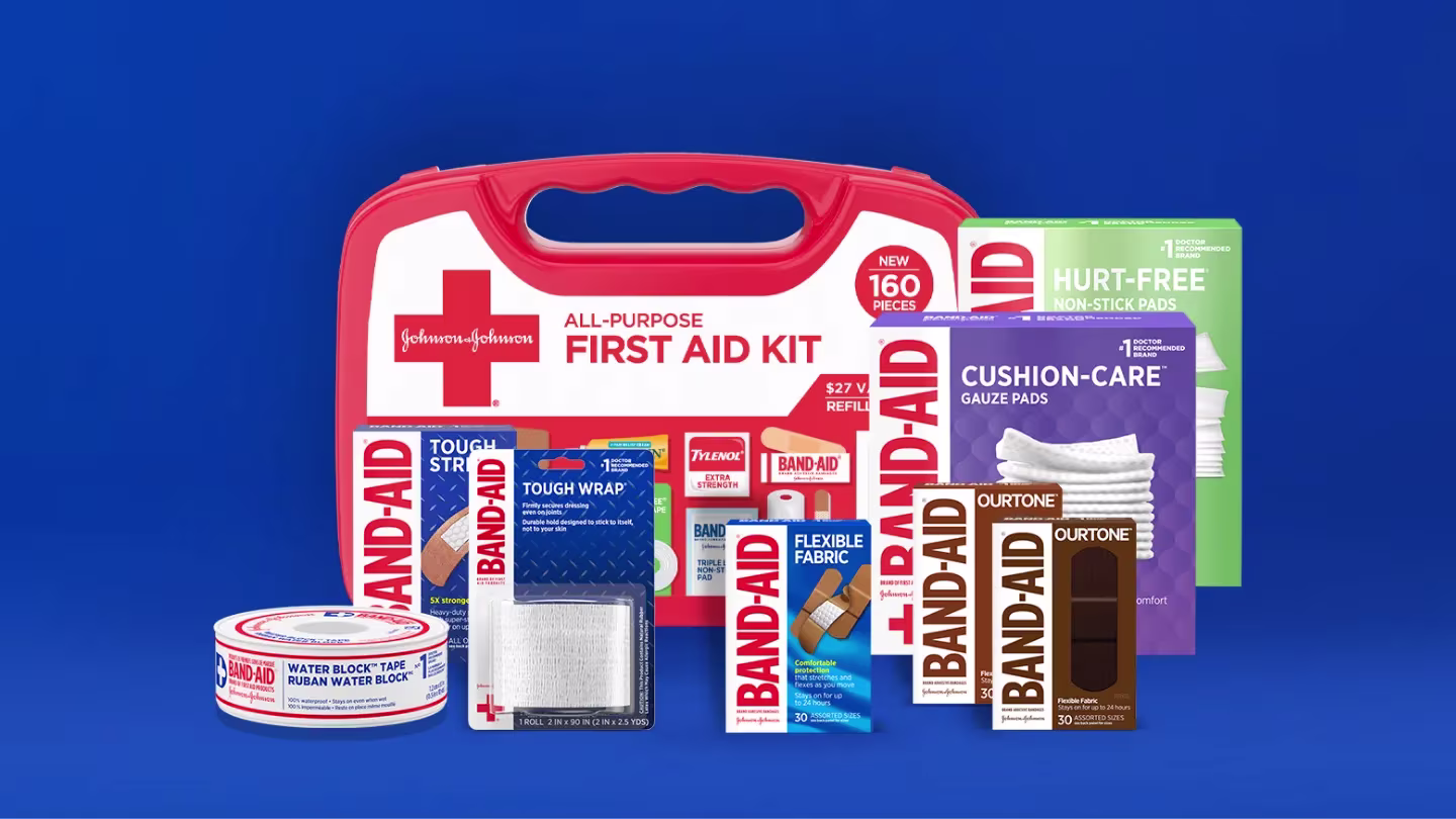 All-purpose first aid kit by Band-Aid Brand, featuring various Band-Aid products, gauze pads, non-stick pads, and a roll of water block tape against a blue background.