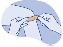 Placing a Band-Aid® Brand Adhesive bandage on a wound.