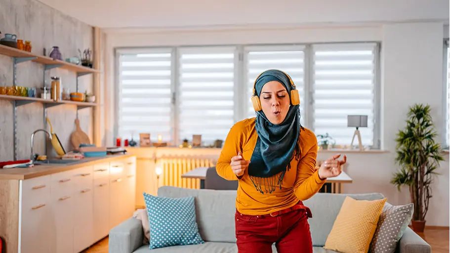 Person wearing headphones dancing indoors