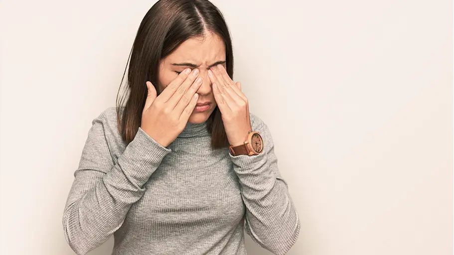 Person touching their eyes