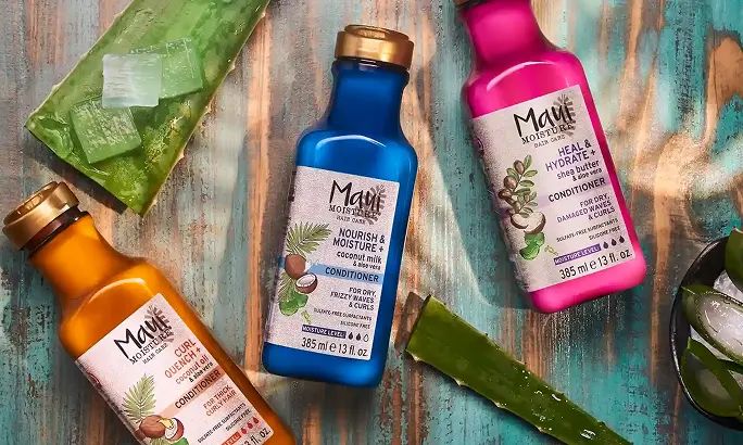 Maui Moisture® conditioner products surrounded by aloe leaves