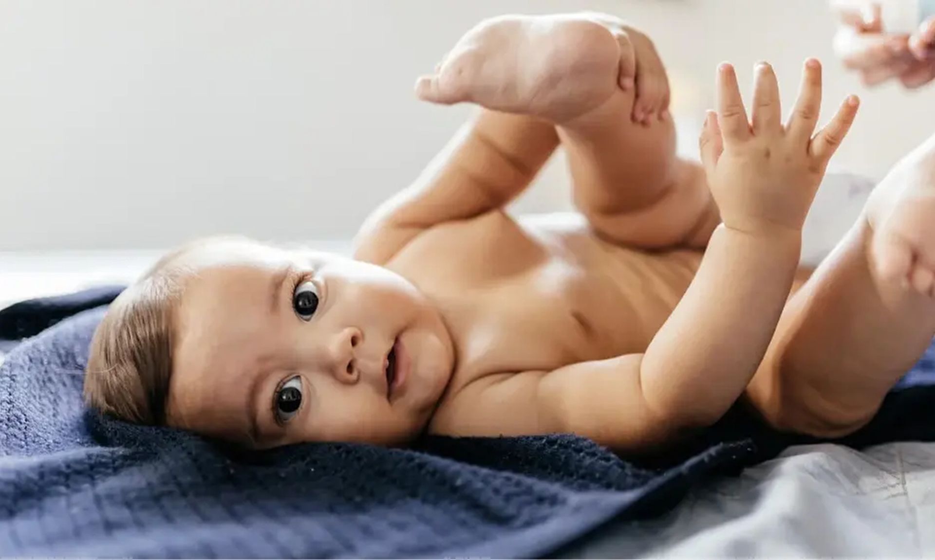 Baby gently playing with the feet, highlighting a moment of joy