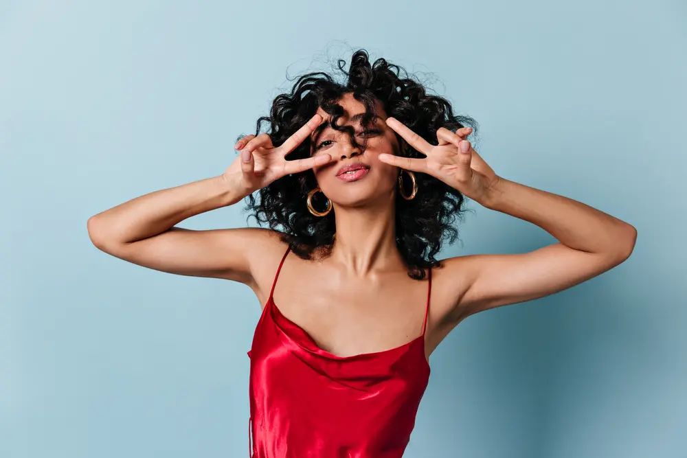Woman with healthy curls and frizz-free after using Maui Moisture® products