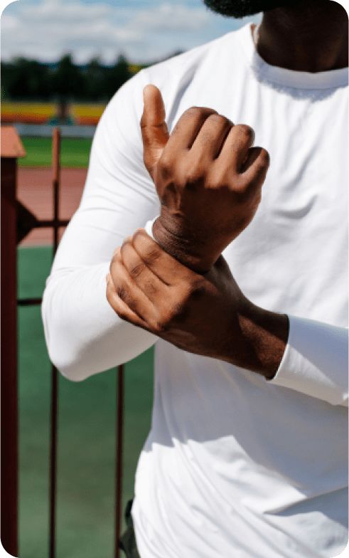 Man grasping his sprained wrist.