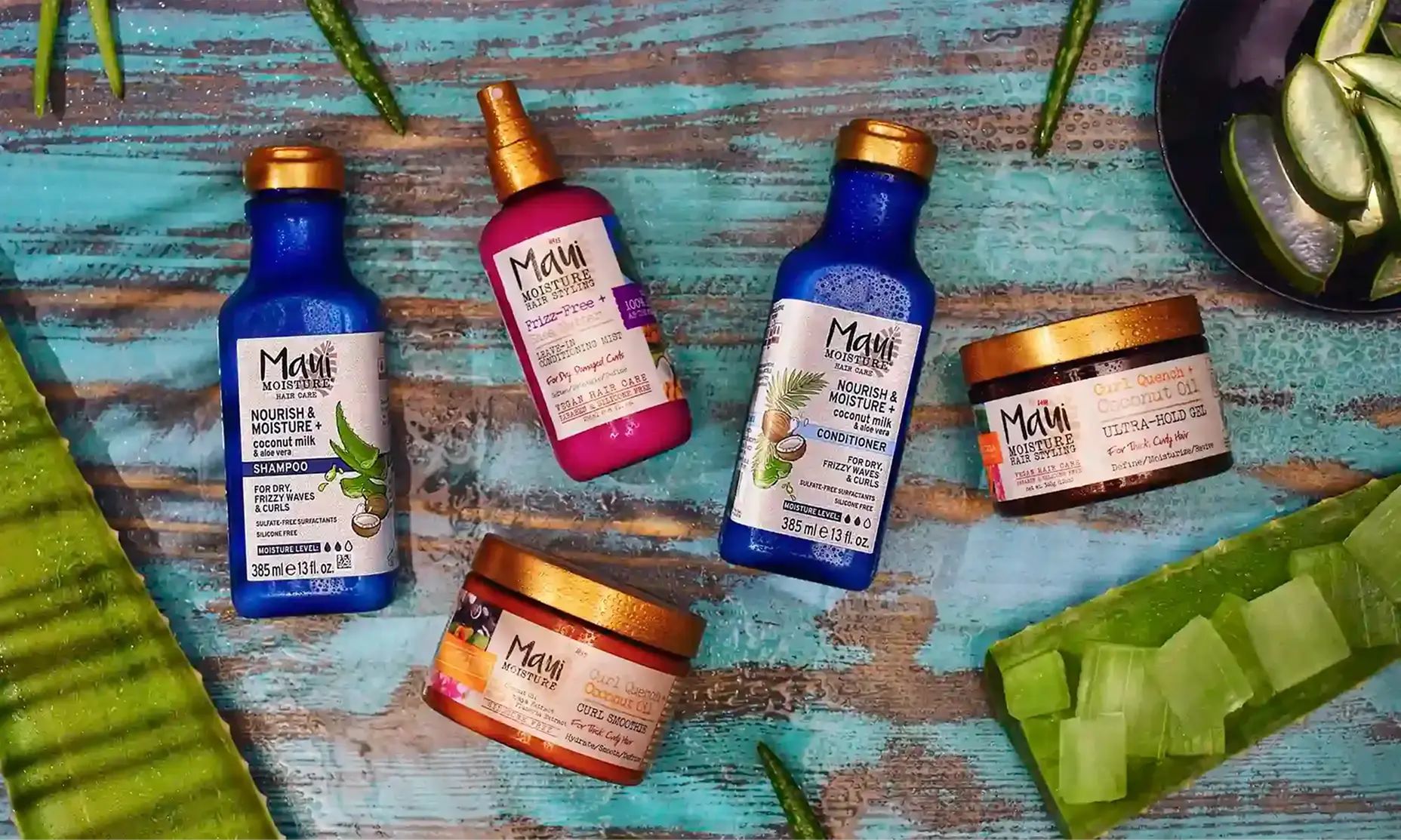 Maui Moisture® shampoo, conditioner and treatment products surrounded by aloe leaves