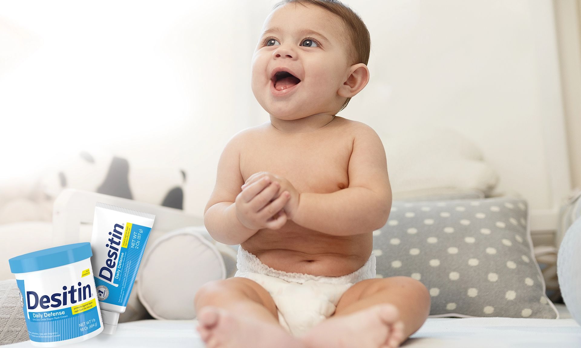 Desitin® Daily Defense Collection, a baby radiantly smiling when looking around