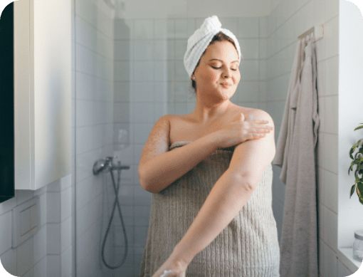 Woman practicing self after taking a shower