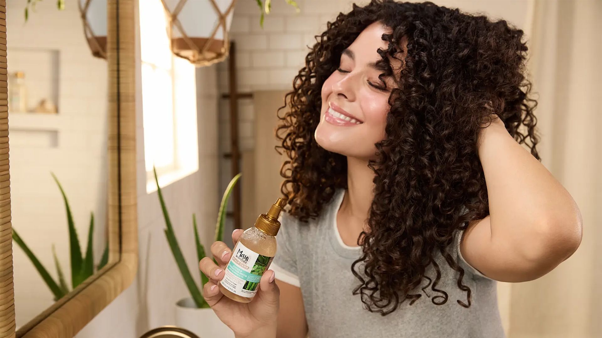 Smiling Woman with healthy curls using Maui Moisture Scalp Care Serum