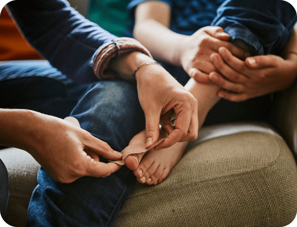 Person putting a bandage on a toe