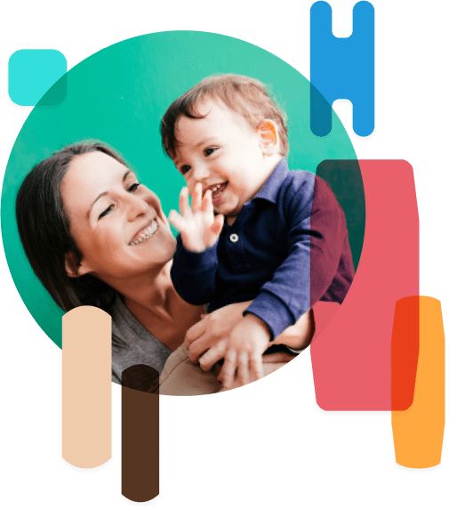 Woman smiling and holding up a small child.