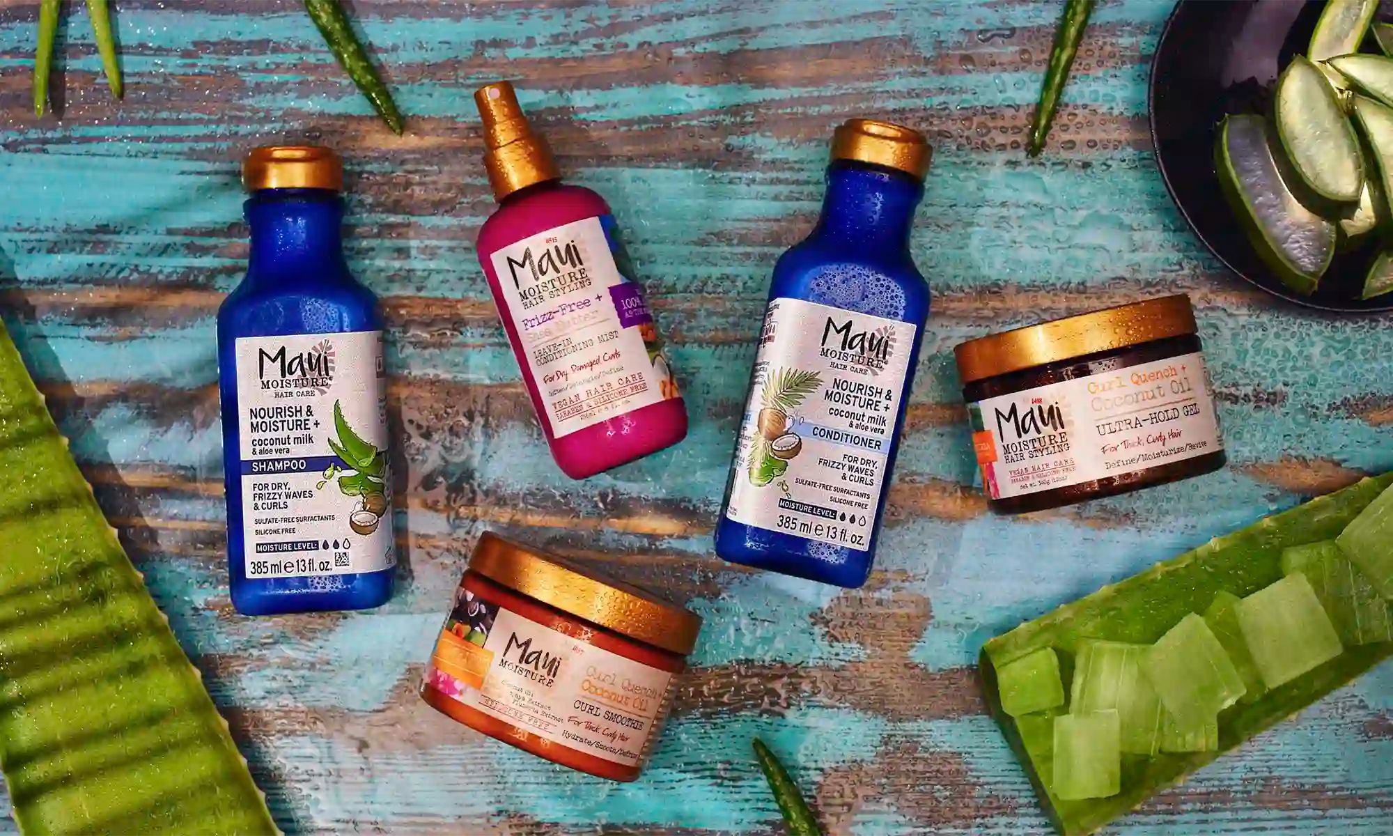 Maui Moisture® shampoo, conditioner and treatment products surrounded by aloe leaves