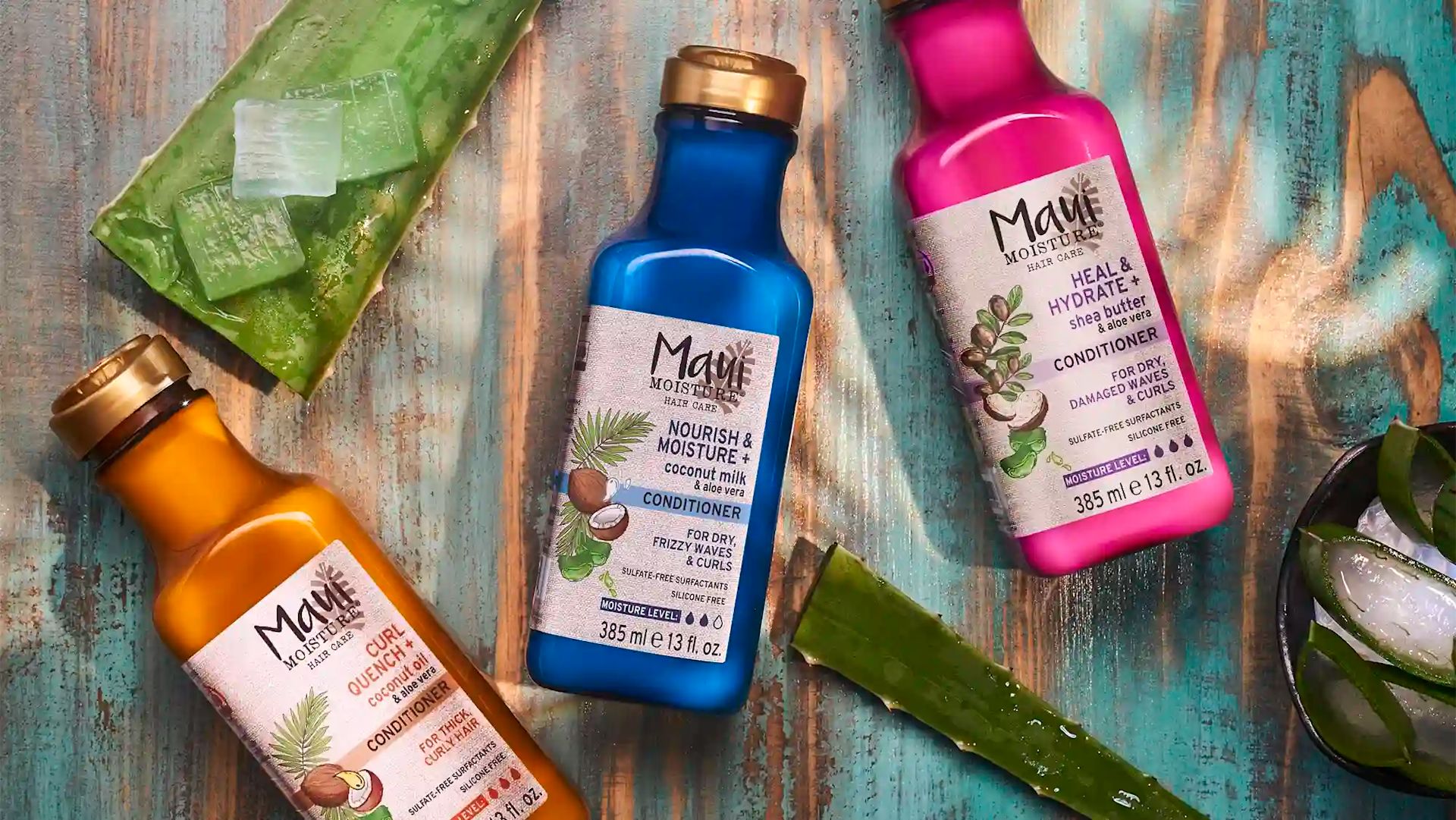  Maui Moisture® conditioner products surrounded by aloe leaves