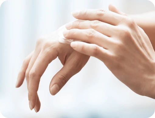 Person applying NEOSPORIN ointment to knuckles