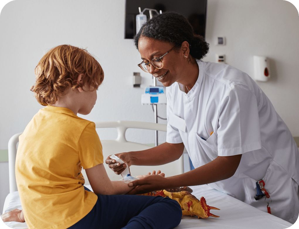 Doctor caring for a wound on a young child’s arm.