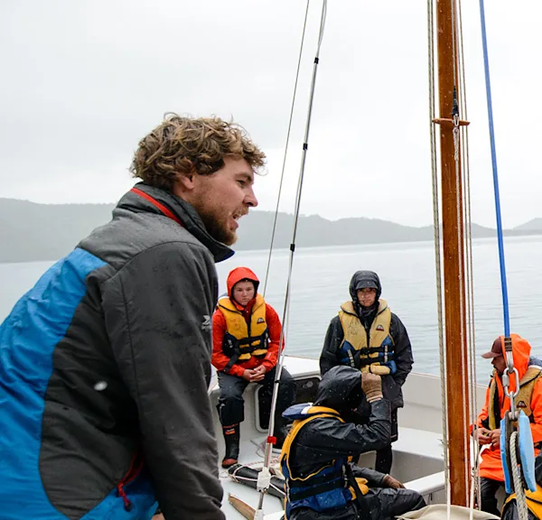 Kaiako (instructor) talking to students on the sailing scheme
