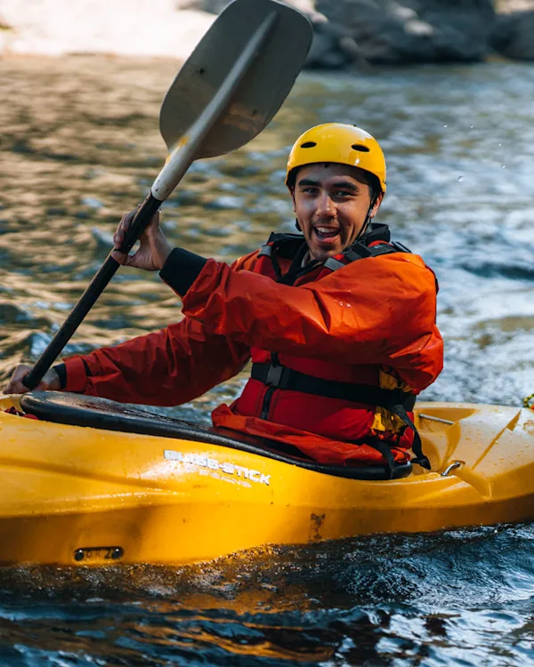 Young adult kayaking on three-week course