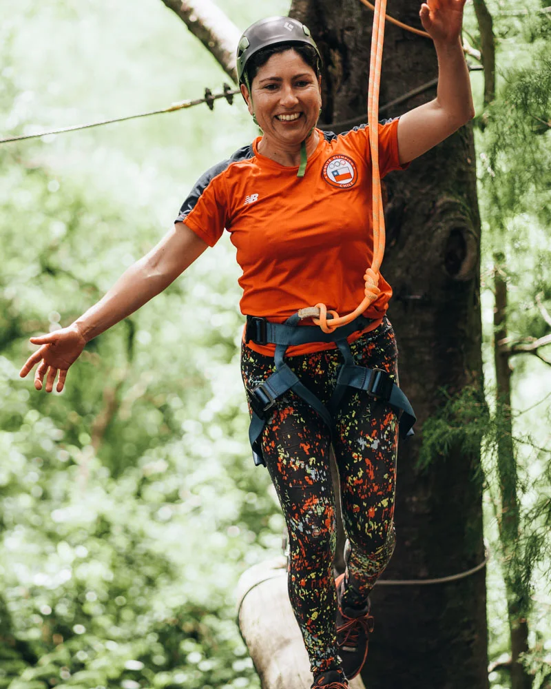 An adult on the high ropes course at Anakiwa