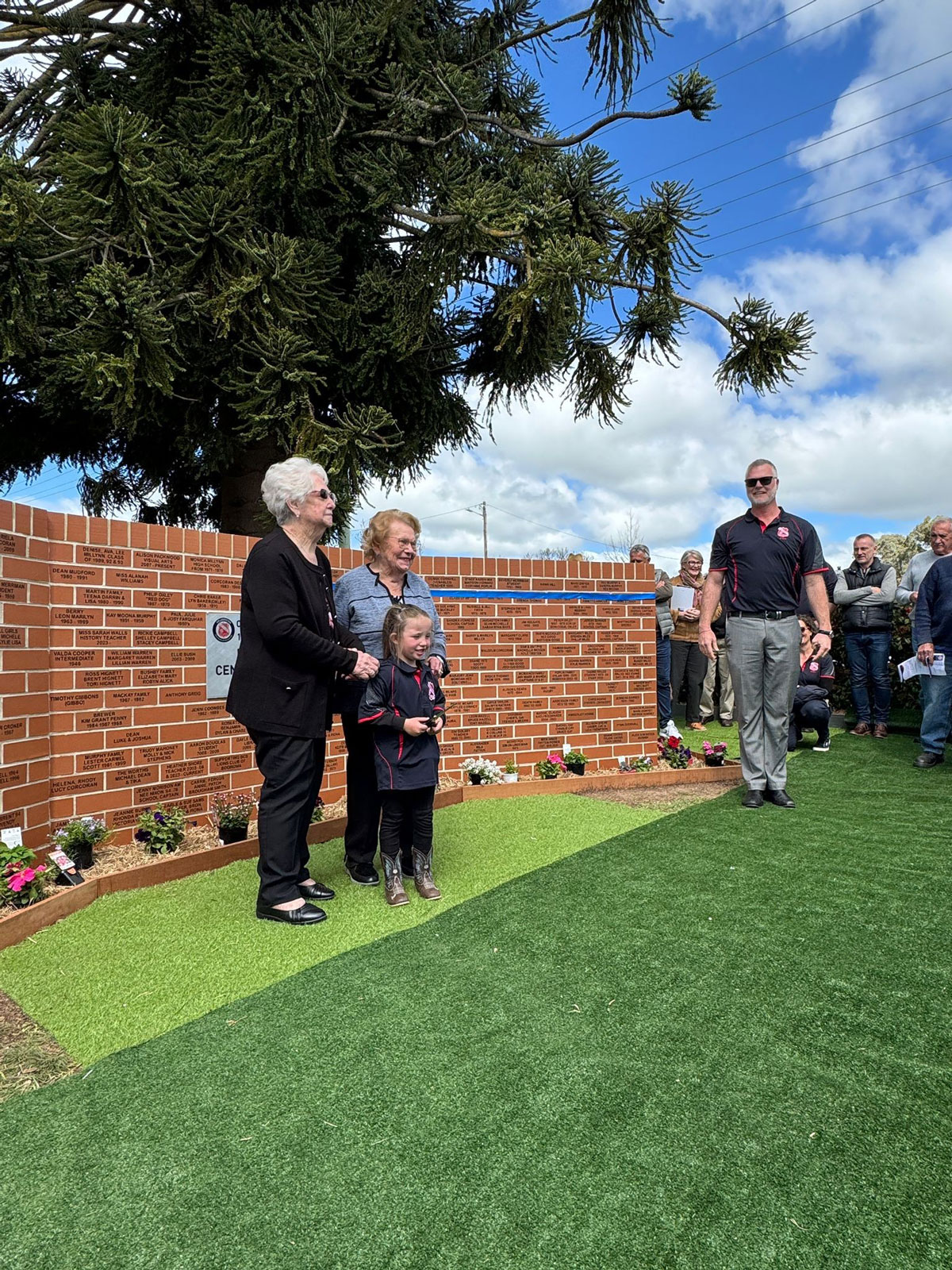 Oldest-living-ex-students-Gloria-Glover-and-Ruth-Small-+-youngest-current-student-Aria-after-cutting-the-ribbon-for-the-Commemorative-Wall