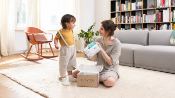 Mother and son unpacking their LILLYDOO diaper subscription box