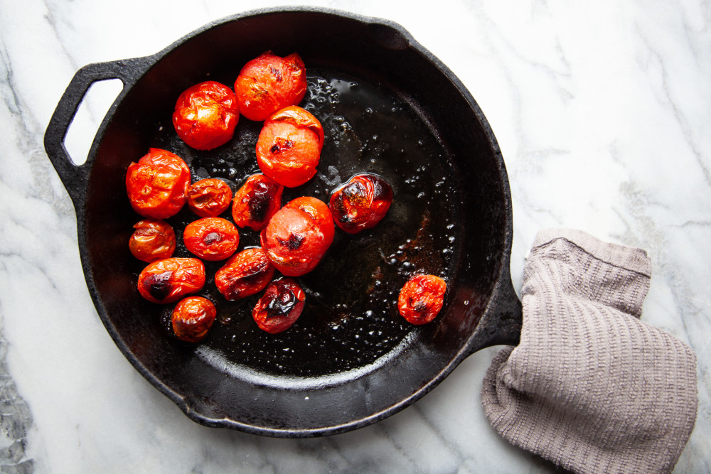 Place tomatoes in an oven proof skilled or on a small baking sheet, drizzle with 1 tablespoon of olive oil and season with a pinch of salt.